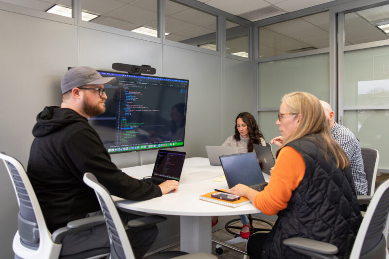 A group has a discussion in one of the 20Fathoms conference rooms.